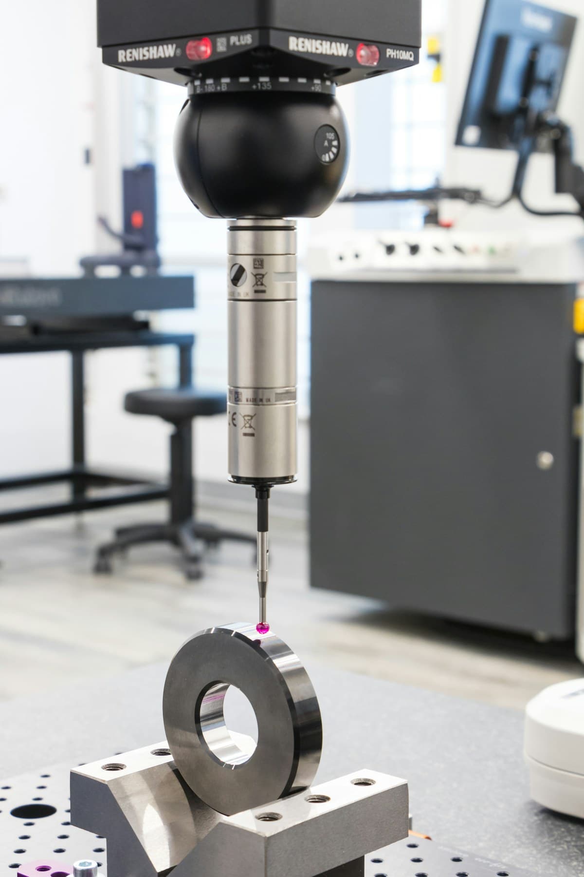 A precision measurement probe inspecting a metal component