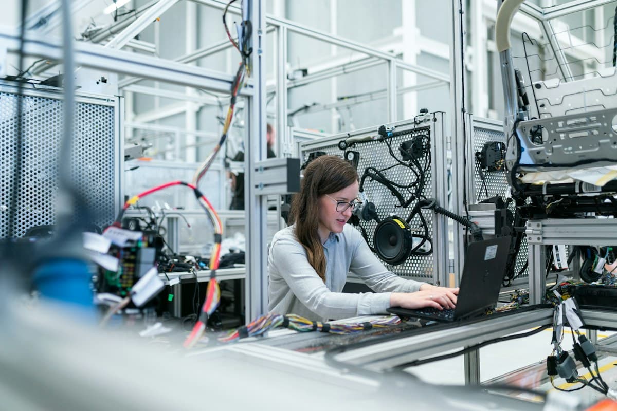 Engineer working with equipment on a modern manufacturing floor