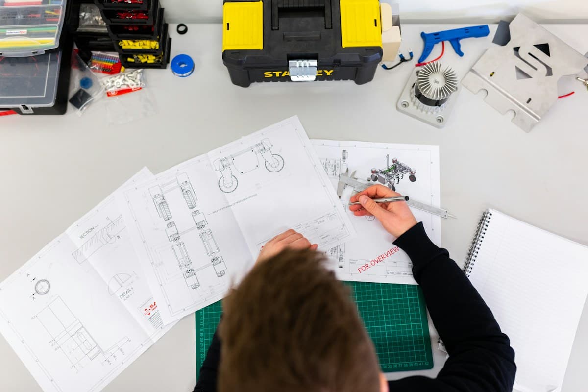 Engineer reviewing a technical drawing at a workbench